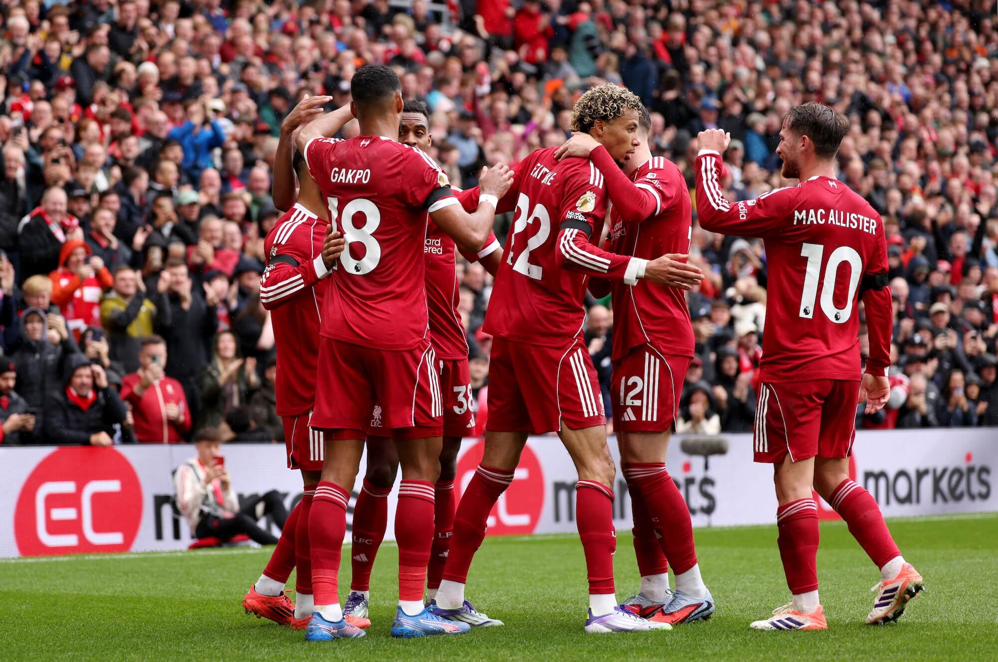 Liverpool FC players celebrating a goal together